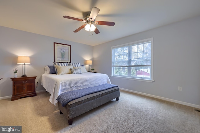 bedroom featuring light carpet and ceiling fan