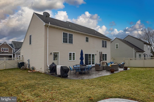 back of property featuring an outdoor living space, a yard, and a patio area