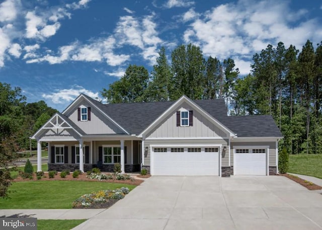 craftsman-style home featuring a garage, a porch, and a front yard