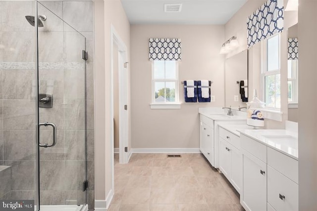 bathroom with a shower with door and vanity