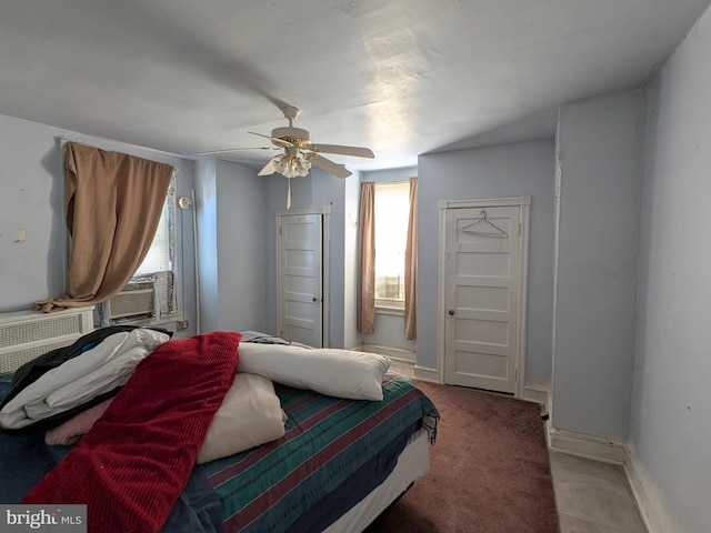 carpeted bedroom featuring ceiling fan and multiple windows