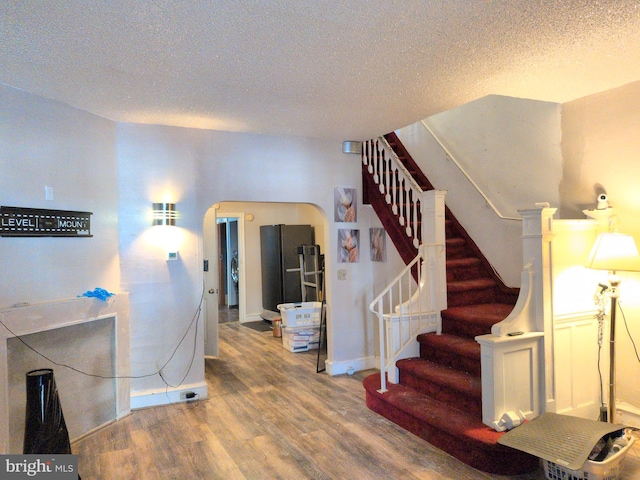 interior space featuring hardwood / wood-style flooring and a textured ceiling