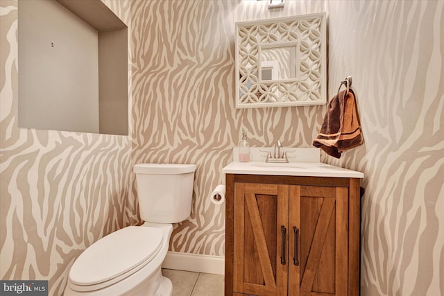 bathroom featuring vanity, tile patterned floors, and toilet