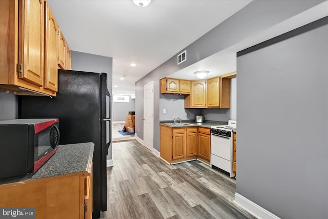 kitchen with hardwood / wood-style flooring, sink, and white range with electric stovetop