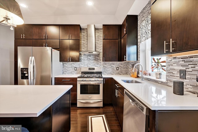 kitchen with dark hardwood / wood-style floors, sink, backsplash, stainless steel appliances, and wall chimney exhaust hood