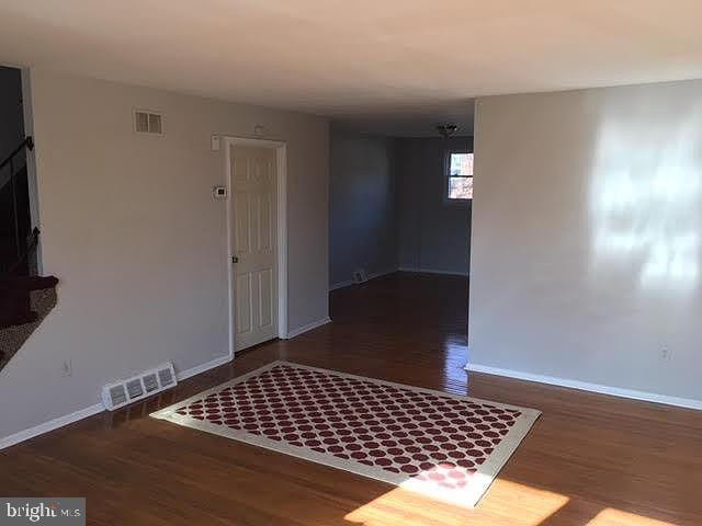 empty room with dark hardwood / wood-style floors