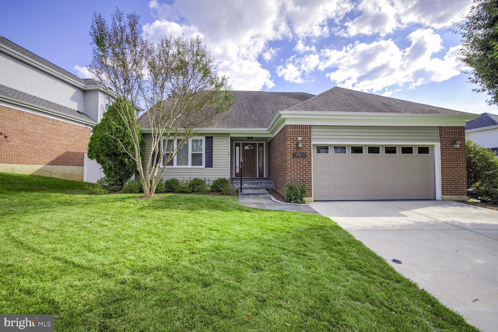 ranch-style home with a garage and a front yard