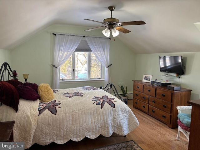 bedroom with light hardwood / wood-style flooring, ceiling fan, and vaulted ceiling