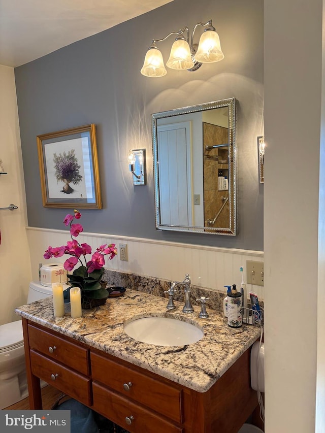 bathroom featuring vanity and toilet