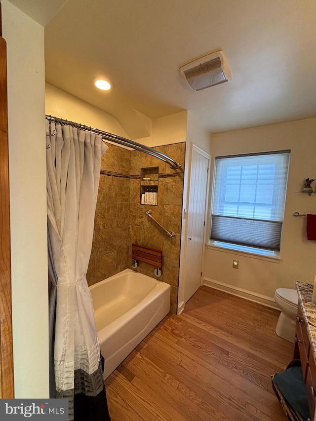 full bathroom with shower / bath combo with shower curtain, wood-type flooring, toilet, and vanity