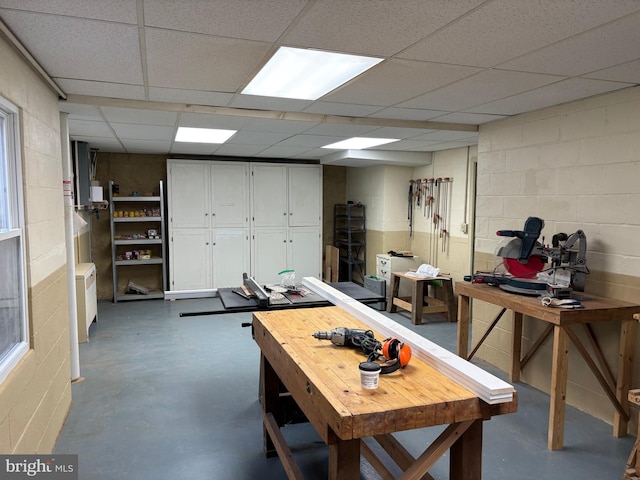 interior space with a workshop area and a drop ceiling