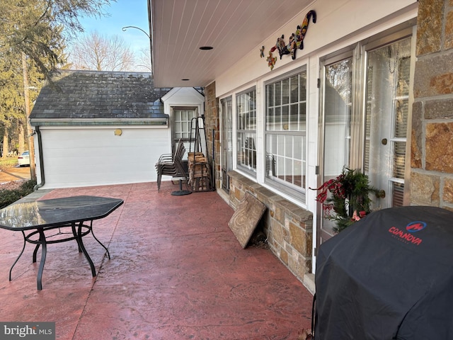 view of patio with an outbuilding, area for grilling, and a garage