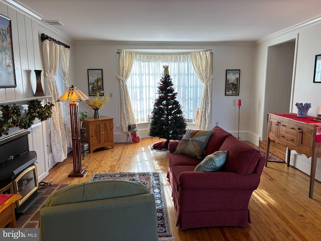 living room with hardwood / wood-style flooring and ornamental molding