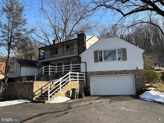 view of front of house with a garage and a balcony