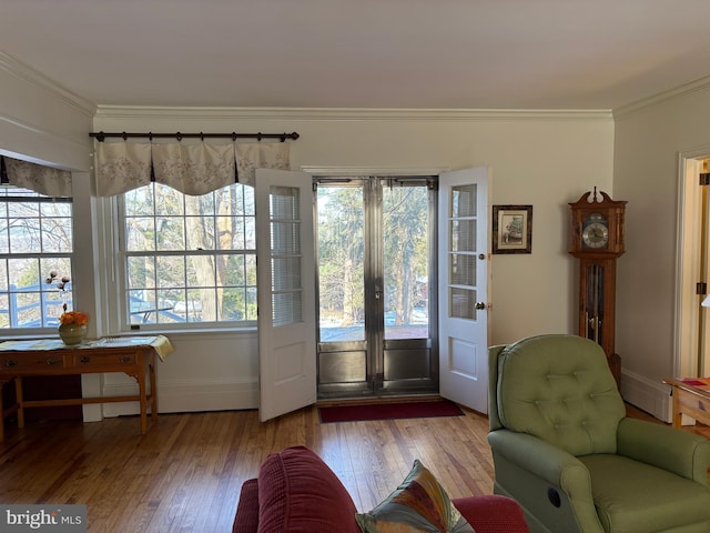 doorway to outside with crown molding and light hardwood / wood-style floors