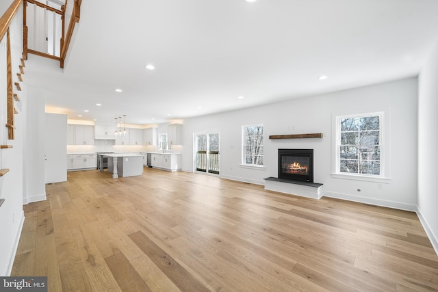 unfurnished living room with light wood-type flooring