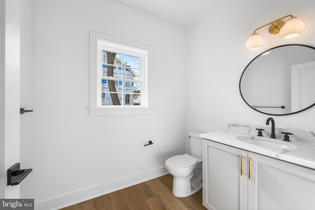 bathroom featuring hardwood / wood-style flooring, vanity, and toilet