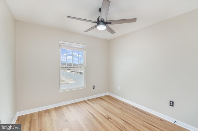 empty room with ceiling fan and light hardwood / wood-style floors