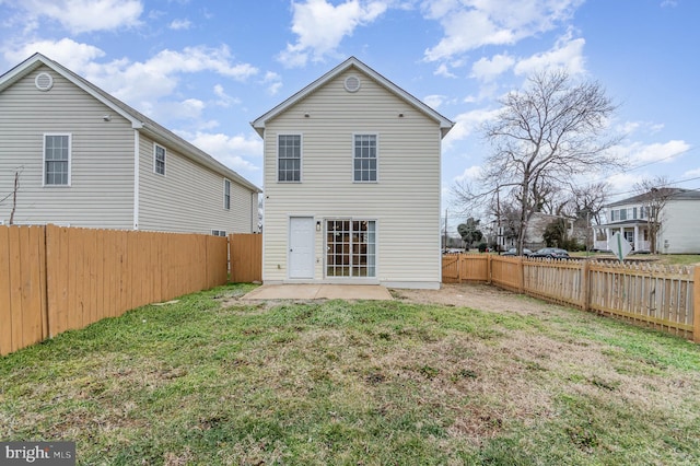 rear view of house featuring a yard and a patio