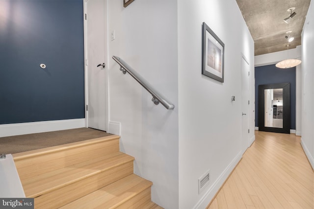 stairs with wood-type flooring