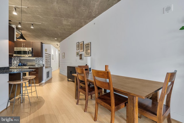 dining space with light hardwood / wood-style floors