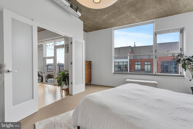 bedroom featuring light colored carpet