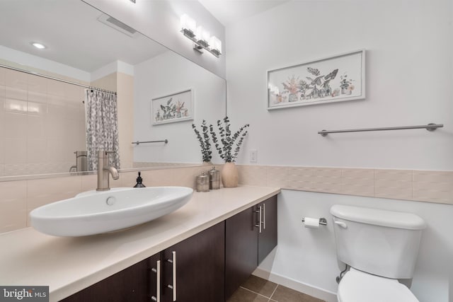 bathroom with tile patterned flooring, vanity, a shower with curtain, and toilet