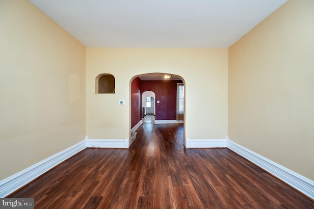 unfurnished room featuring dark hardwood / wood-style flooring