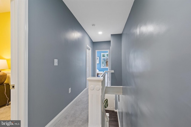 hallway featuring light carpet