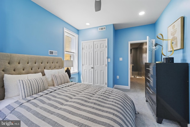 carpeted bedroom featuring ceiling fan and a closet