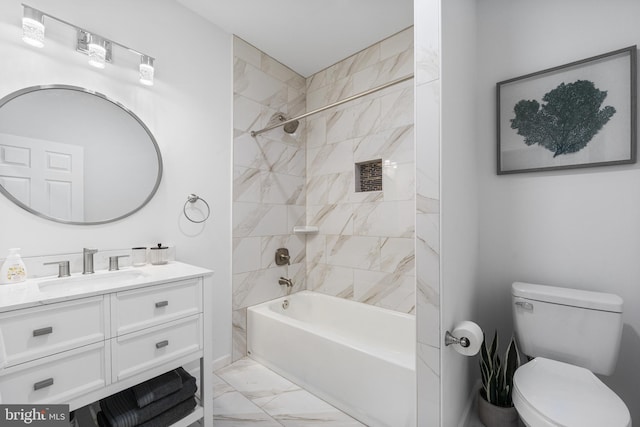 full bathroom with tiled shower / bath, vanity, and toilet