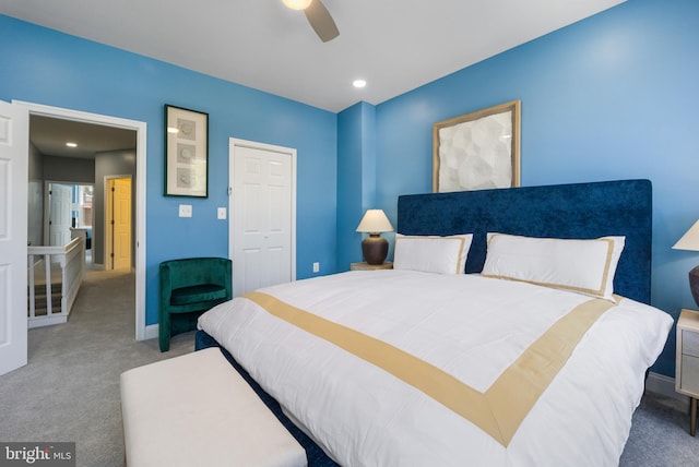 carpeted bedroom with ceiling fan and a closet