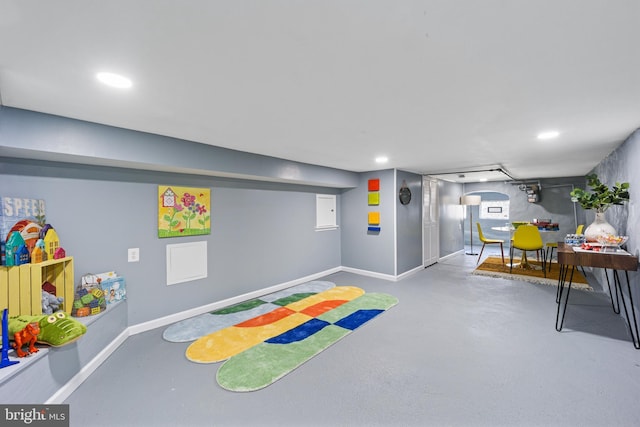 rec room with concrete floors