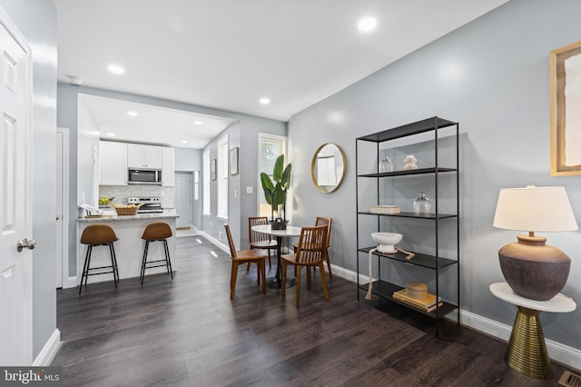 dining space with dark wood-type flooring