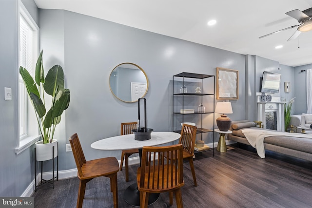 dining space featuring ceiling fan and dark hardwood / wood-style floors