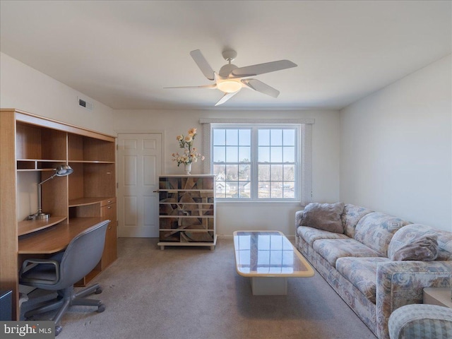 carpeted home office with ceiling fan