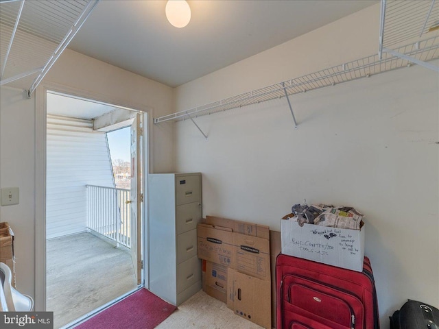 walk in closet featuring light colored carpet