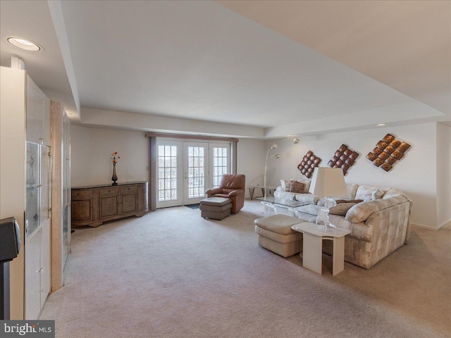 living room featuring french doors and light colored carpet