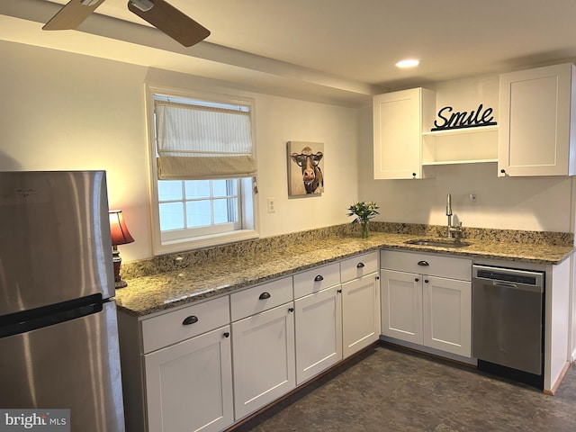 kitchen with white cabinetry, sink, stainless steel appliances, and stone counters