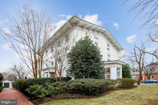 view of side of home featuring a lawn