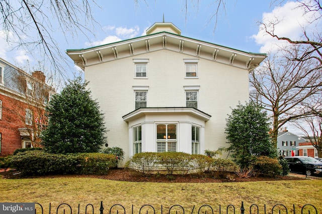 view of home's exterior with a lawn