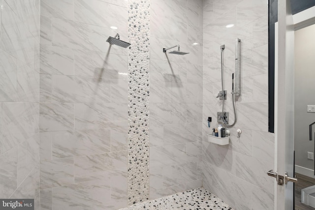 bathroom with a tile shower