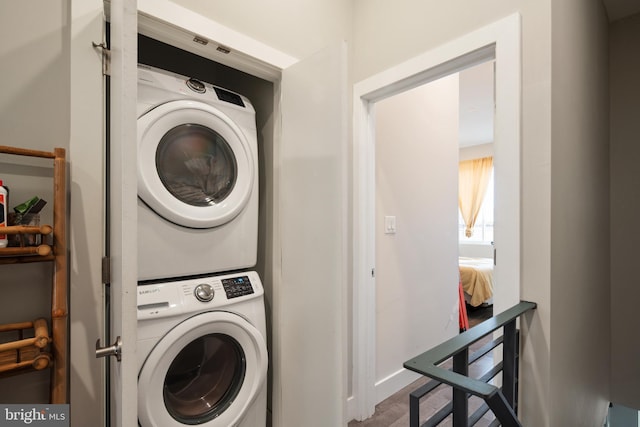 washroom featuring stacked washer and dryer