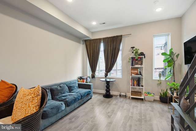 sitting room featuring a wealth of natural light, baseboards, wood finished floors, and recessed lighting