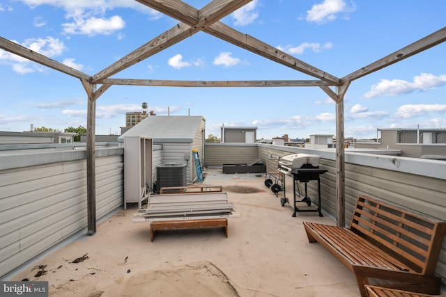 view of patio / terrace featuring a storage shed, an outbuilding, central AC, and area for grilling