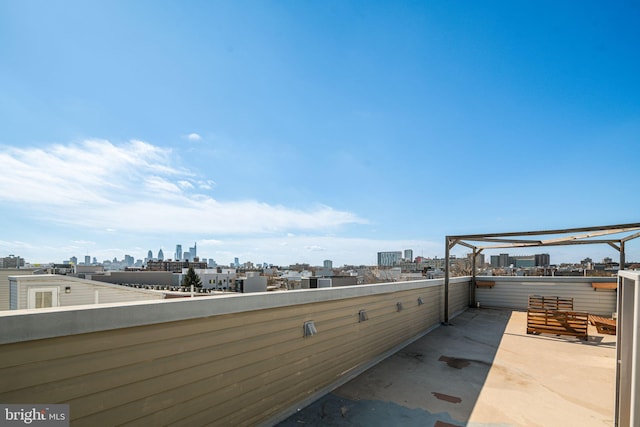 view of patio with a view of city and a balcony