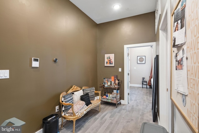 interior space with baseboards and light wood finished floors