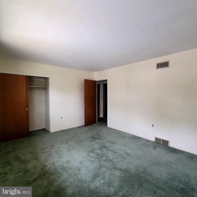 unfurnished bedroom with dark carpet