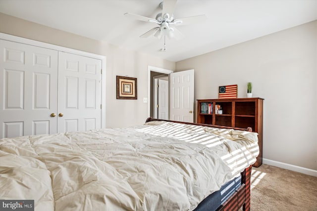 bedroom with light carpet, a ceiling fan, baseboards, and a closet