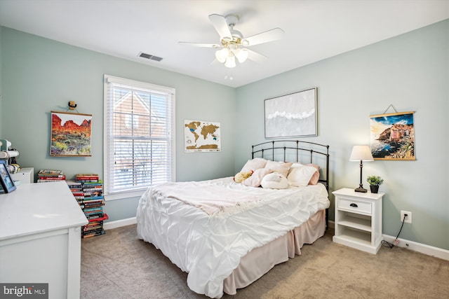 bedroom featuring light carpet, baseboards, visible vents, and a ceiling fan